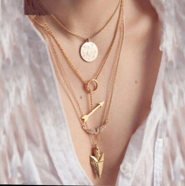 stylish golden colored ladies necklace with 3 layered chains and 3 different pendants